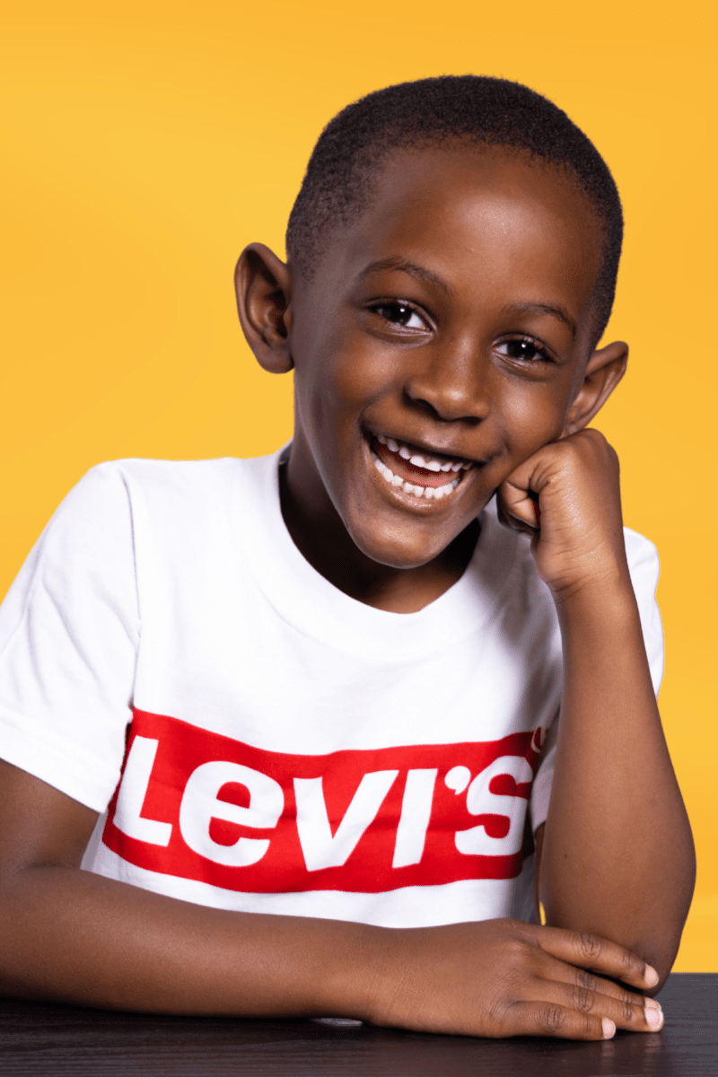 A Young Boy Wearing A Levi'S T - Shirt.