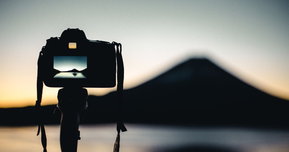 A Photo Of A Camera With A Mountain In The Background, Perfect For Beginners In Photography.