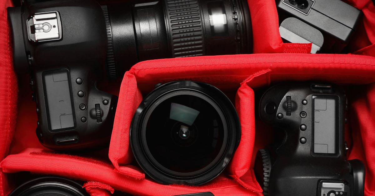 A Red Bag Filled With Various Camera Equipment For Photography Beginners.