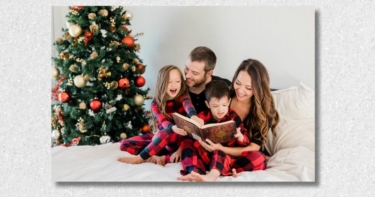 A Family Is Enjoying A Cozy Christmas Mini Session, Reading A Holiday Book By The Twinkling Lights Of Their Decorated Tree.