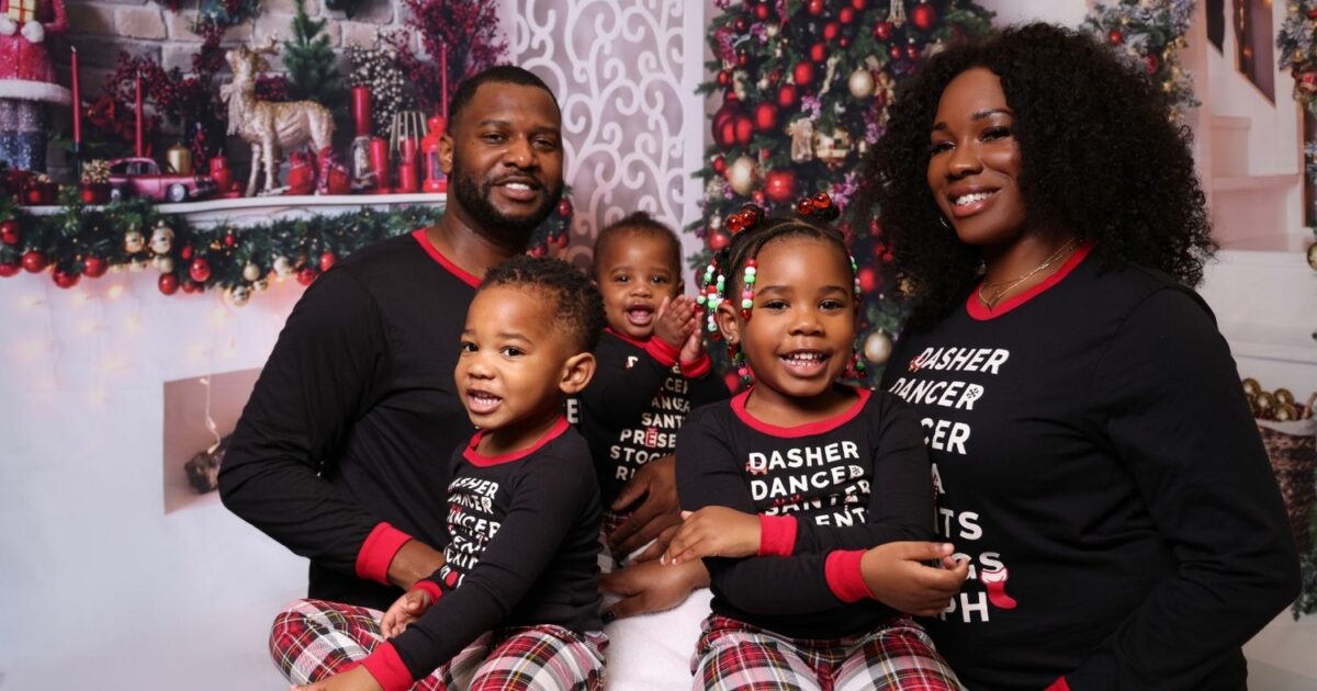 A Family In Christmas Pajamas Posing For A Photo During A Christmas Mini Session.