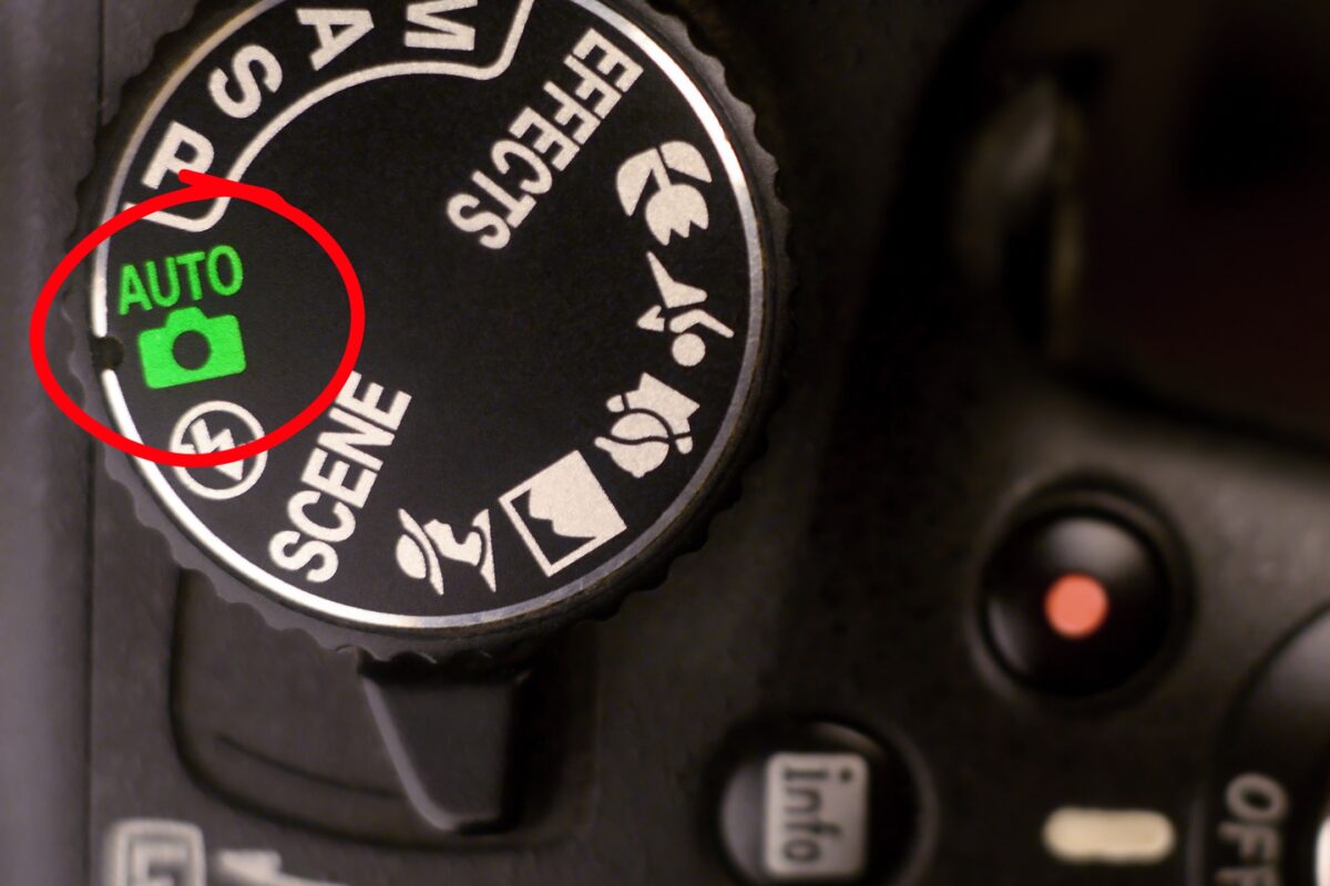 A Close Up Of A Camera With An Auto Button On It.