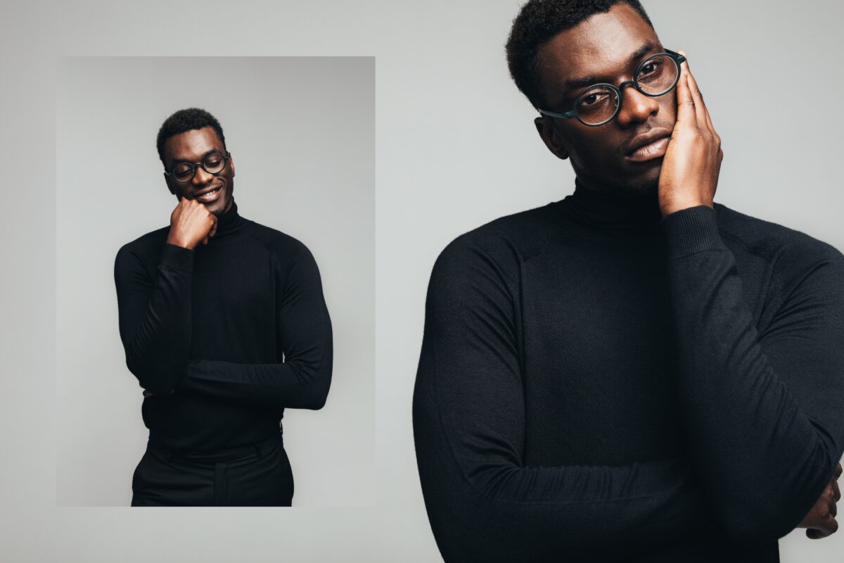 A Stylish Black Man Wearing Glasses And A Black Turtleneck Shirt Who Provides Posing Prompts During A Photo Session.