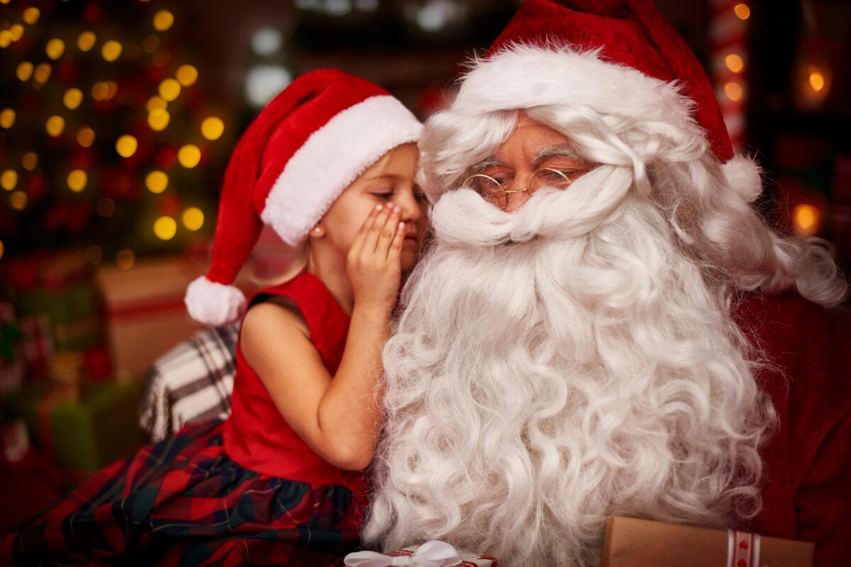 A Heartwarming Santa Claus Photoshoot Captures A Tender Moment As He Shares A Kiss With A Little Girl.