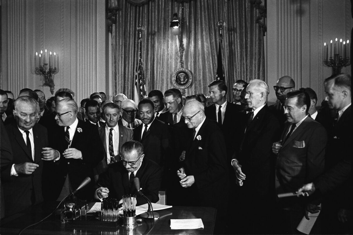 President John F. Kennedy Signing The Civil Rights Bill Highlights Why Photography Is Important.