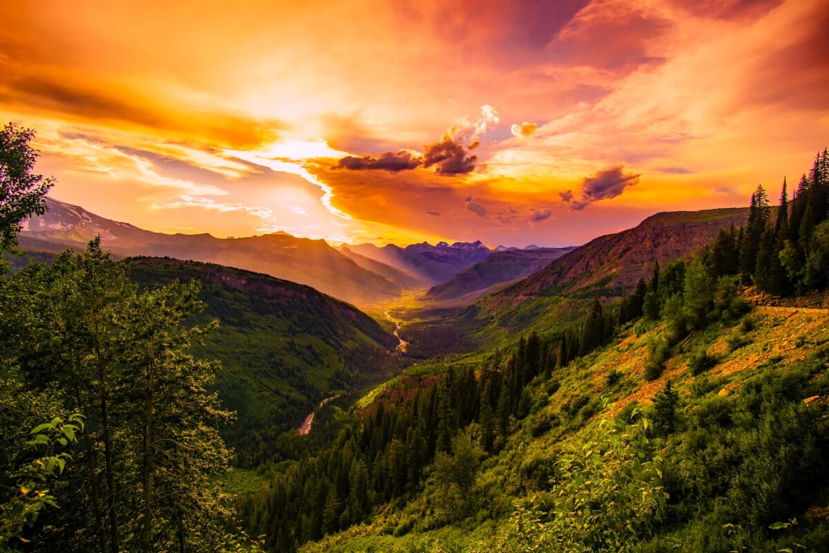 The Sun Is Setting Over A Valley, Showcasing The True Artistry Of Nature'S Beauty.