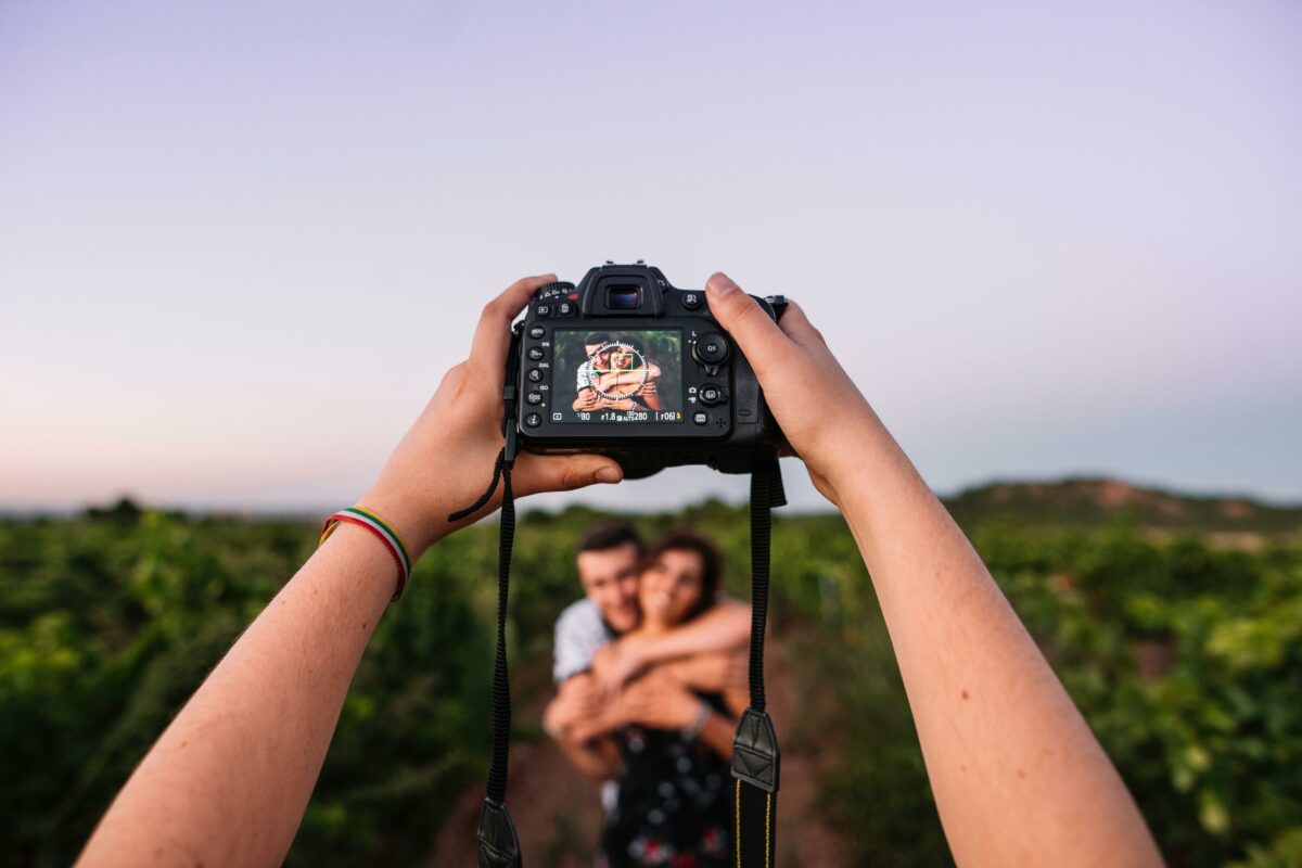A Couple Capturing A Picturesque Moment In A Vineyard While Avoiding Camera Mistakes.