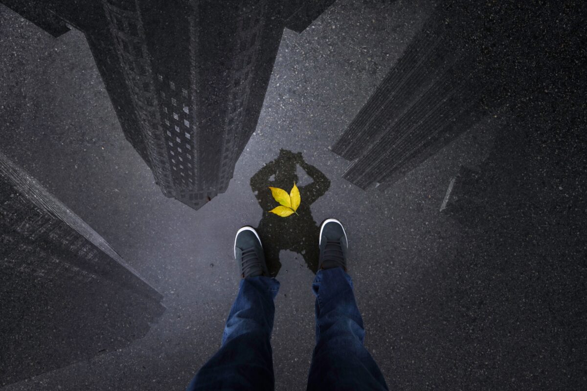 A Person'S Feet Standing On Top Of A Building, Capturing An Amazing Mobile Photography Shot With A Yellow Bird Perched Nearby.