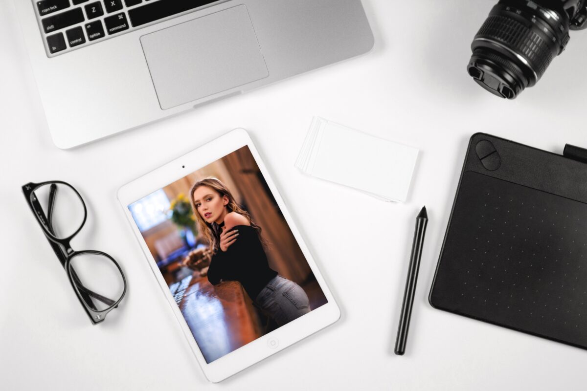 An Ipad With A Photo Of A Woman Next To A Laptop And Camera, Capable Of Turning Photos Into Art.