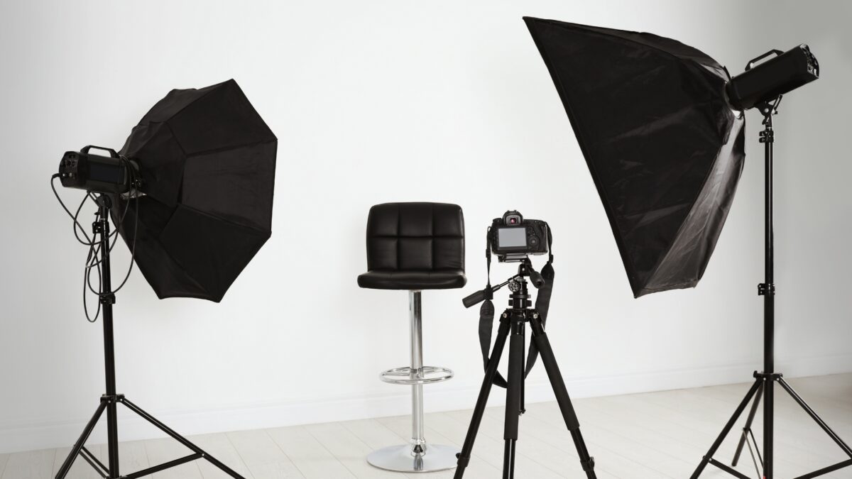 A Photography Studio Equipped With A Tripod, Lights, And A Chair For The Perfect Photography Lighting Setup.
