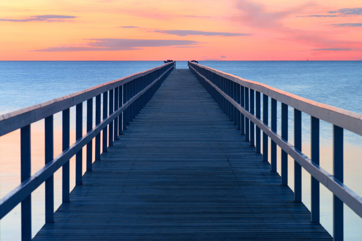 A Picturesque Wooden Pier, Perfectly Captured In A Stunning Composition.