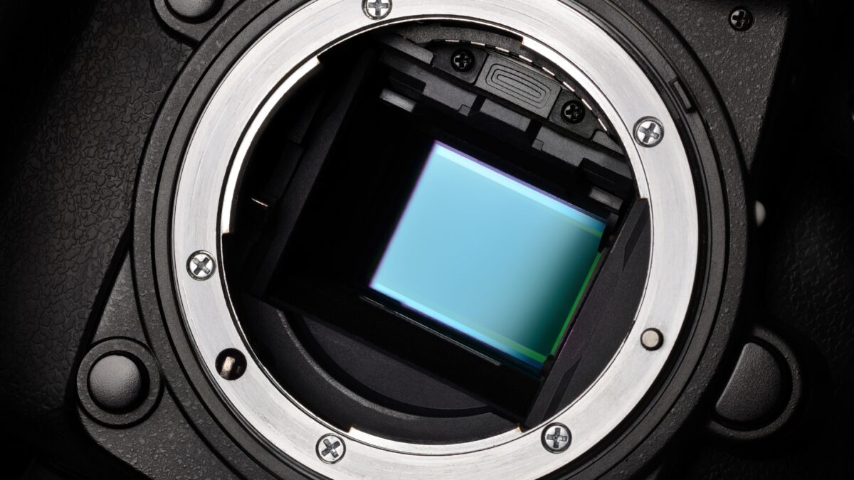A Close Up Of A Camera Lens With A Blue Screen, Showcasing The Functionality Of A Camera.