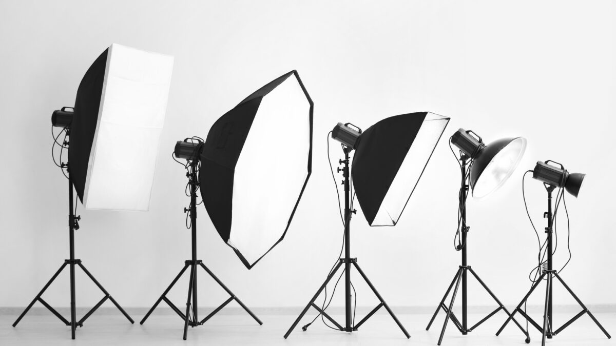 A Black And White Photo Featuring A Group Of Photo Studio Lights, Creating The Perfect Ambiance For Indoor Photos.
