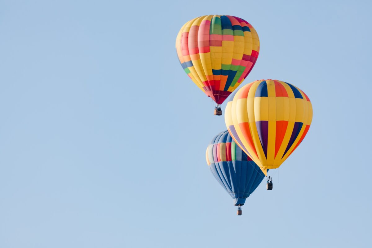 Three Colorful Hot Air Balloons Flying In The Sky Captured In A Stunning Composition In Photography.