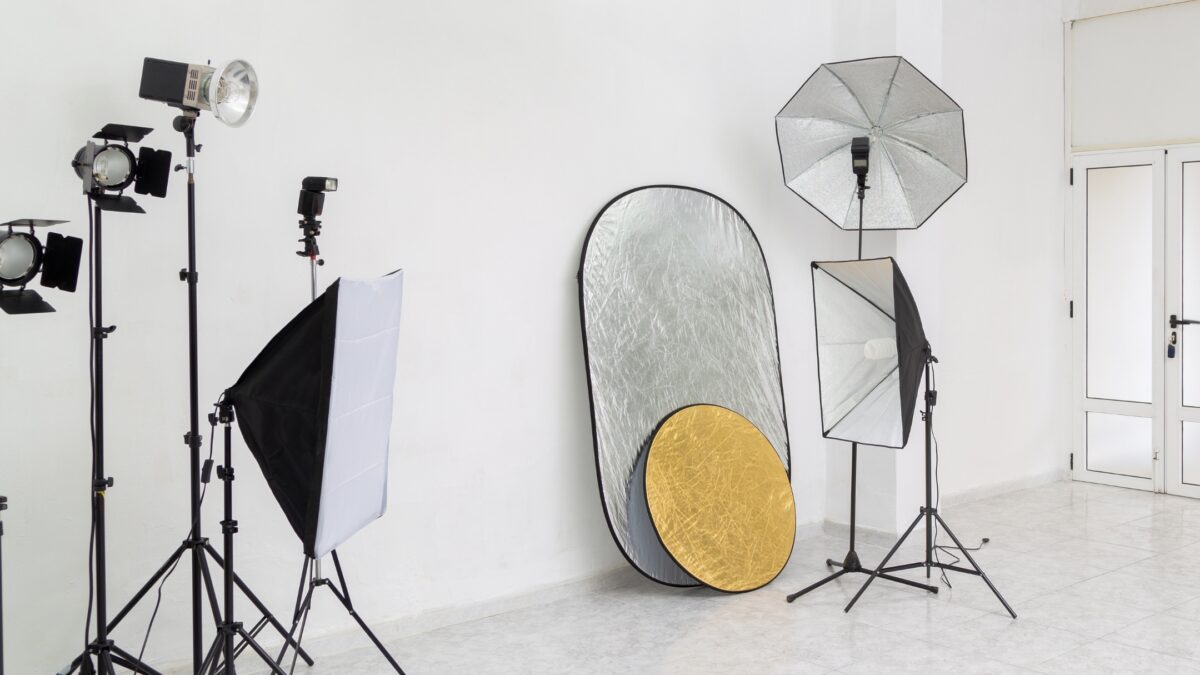 A Photography Studio With A Variety Of Lighting Equipment For Efficient Lighting Setup.