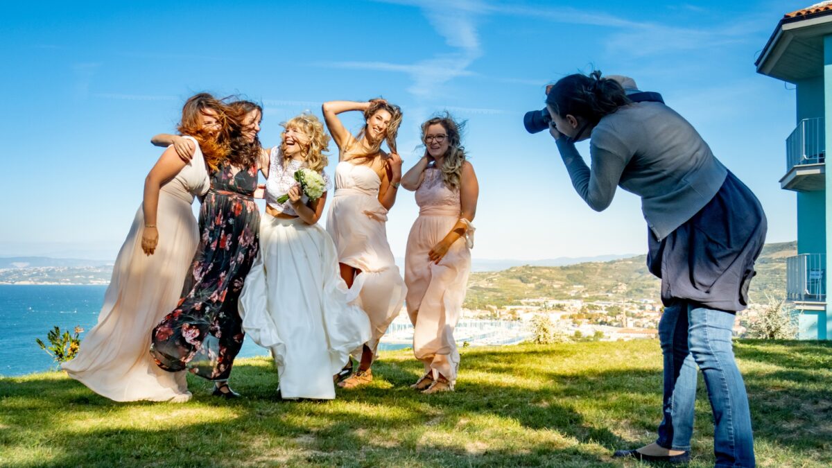 A Bride And Her Bridesmaids Pose For A Photo.