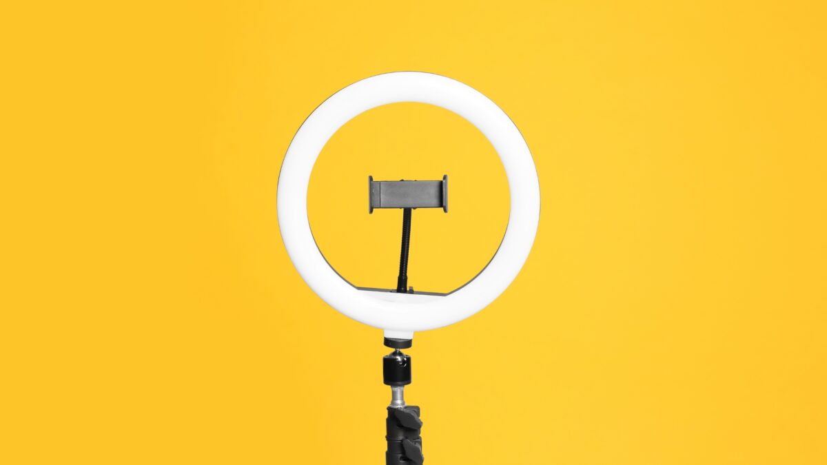 A Photography Ring Light On A Yellow Background.